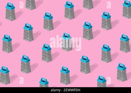 Creative colorful pattern of grater on light pink background.  Kitchen symbol. Cooking utensil. Cutlery sign. Trendy Minimal concept. Stock Photo