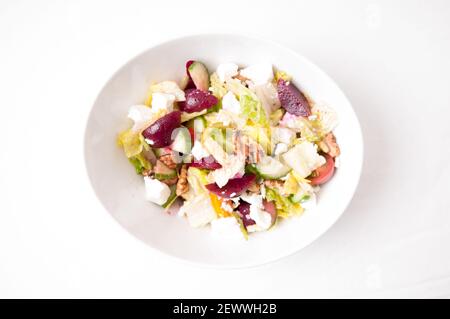 tasty walnut and beet salad with goat cheese crumbled on top Stock Photo