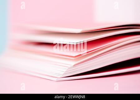 Close up book pages on pastel pink blurred background Stock Photo