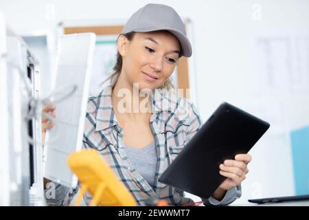 young woman checking data on digital tablet Stock Photo