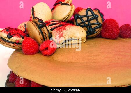 A giant chocolate macaron cake with fresh raspberries Stock Photo