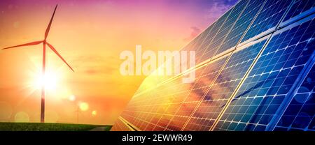 Wind Turbines And Solar Panels At Sunset - Renewable Energy Concept Stock Photo