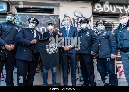 Police Commissioner Dermot Shea (4th from R), Chief of Community Affairs Jeffrey Maddrey (2nd from L), Donald West (3rd from L) pose with auxiliary officers and police explorers after press conference to combat graffiti and improve quality of life on Orchard Street. Initiative to combat graffiti is designed to improve quality of life and to lower crimes in the city. Graffiti causes substantial financial costs to homeowners and merchants and public institutions and facilities. Graffiti is often related to drug and gang violence. There were more than 6,000 complaints in calendar 2020 about prope Stock Photo