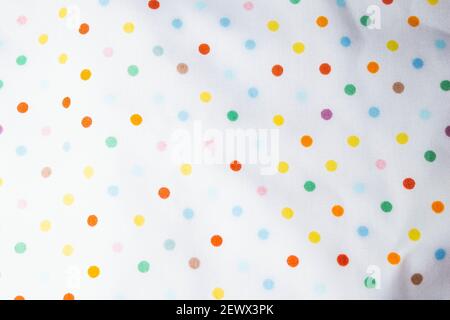 Fabric texture with multi-colored circles. Fabric background with pattern. Rainbow balls on the fabric. Stock Photo