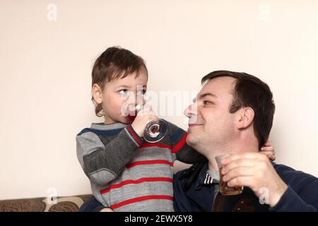Father with his son have drinks in the cafe Stock Photo