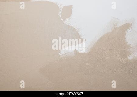 White beige cement texture stone concrete,rock plastered stucco wall. painted flat fade pastel background.decorative relief plaster on wall closeup Stock Photo