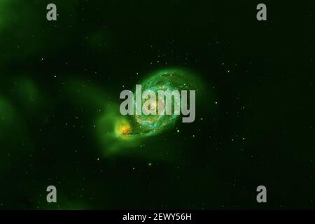 Green spiral galaxy on a dark background. Elements of this image were furnished by NASA. Stock Photo