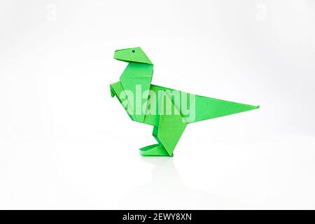 Origami paper dinosaur isolated on white background with copy space Stock Photo