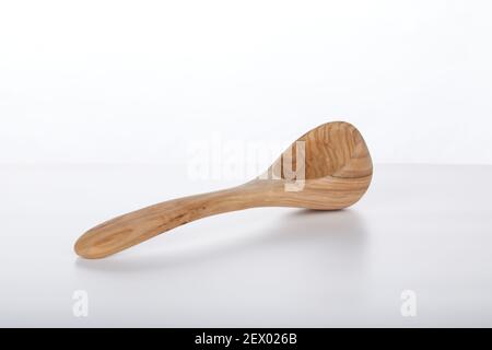 Handmade artisan crafted olive wood Wooden scoop spoon ladle isolated on white background Stock Photo