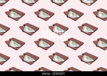 Women's wallet with money on pink background. Seamless patter, creative packing concept Stock Photo