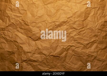 A background or wallpaper with crumpled orange paper textures Stock Photo