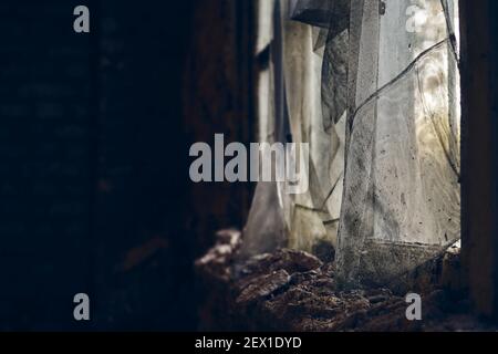 The cobwebs on a window found in the cellar of an abandoned house Stock Photo