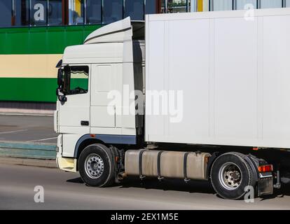 truck on road near an entrance to shop Stock Photo