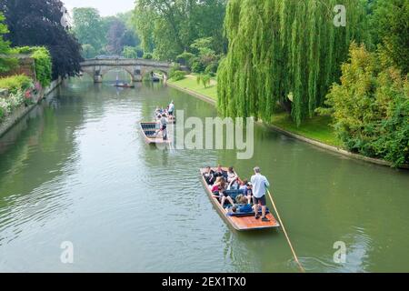 Punting on the river Cam heading towards Trinity College Bridge on a spring day in Cambridge, England, UK