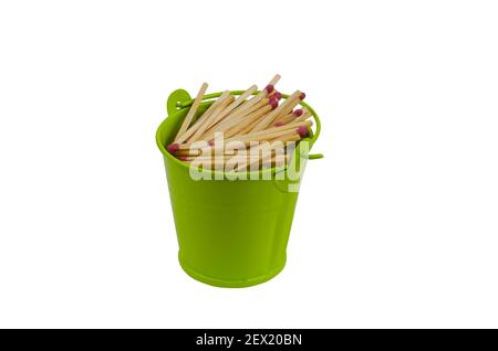 Full bucket of wooden matches on a white background. A group of matches with red heads in a green bucket. Isolated. Stock Photo