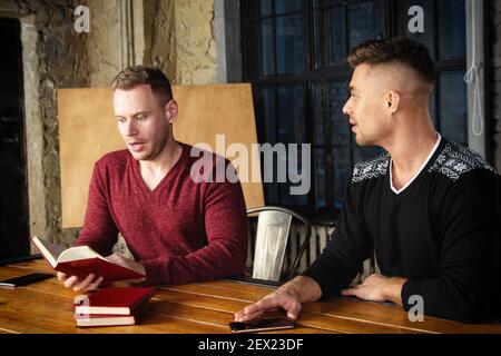 A young group of businessmen are discussing work. Study and work problems. Stock Photo