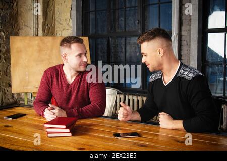 A young group of businessmen are discussing work. Study and work problems. Stock Photo