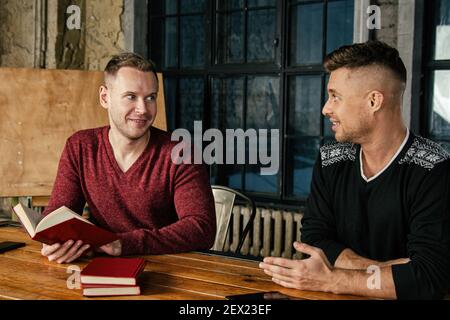 A young group of businessmen are discussing work. Study and work problems. Stock Photo
