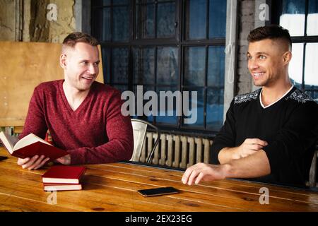 A young group of businessmen are discussing work. Study and work problems. Stock Photo