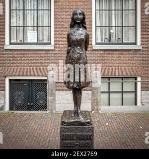 Statue of Anne Frank by sculptor Mari Andriessen, outside the Anne Frank house museum & Westerkerk church, Westermarkt, Amsterdam, Netherlands