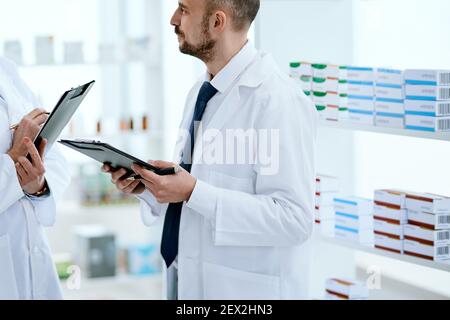 two pharmacists discussing work issues . Medical healthcare and pharmaceutical service. Stock Photo