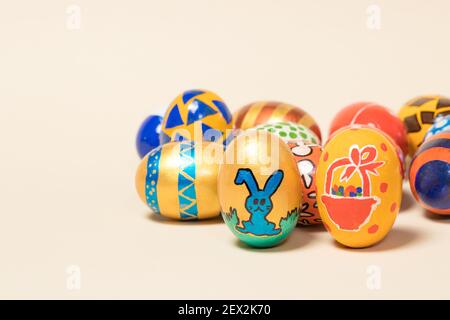 Photo card with copy space for text on a beige light background with festive painted Easter eggs Stock Photo