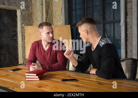A young group of businessmen are discussing work. Study and work problems. Stock Photo