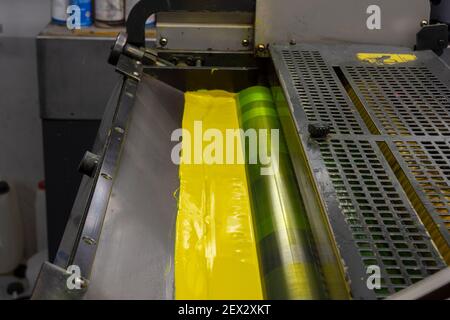 Color and glossy rollers of offset printing machine. offset ink colour.  Yellow Stock Photo