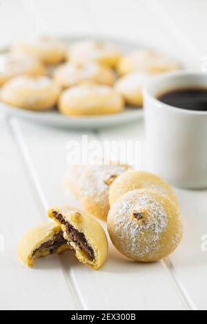 Cookies with chocolate cream. Sweet biscuits on white table. Stock Photo