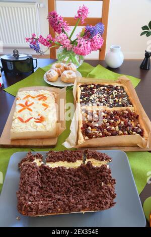 Easter cakes in Poland. Easter foods: babka cakes, mazurek flat short cakes and cheesecake. Stock Photo