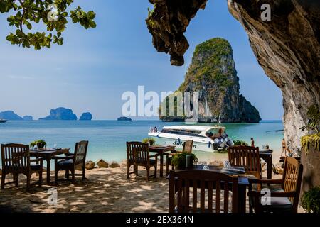 restaurant dinner tables or lunch on the beach Railay beach with a beautiful backdrop of Ko Rang Nok Island In Thailand Krabi. cliffs in Krabi on the beach Stock Photo