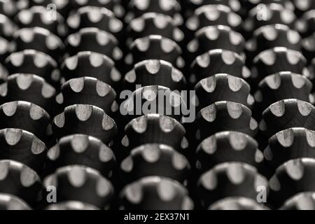 Close-up view of a set of black and white wooden cog wheels with sepia effect Stock Photo