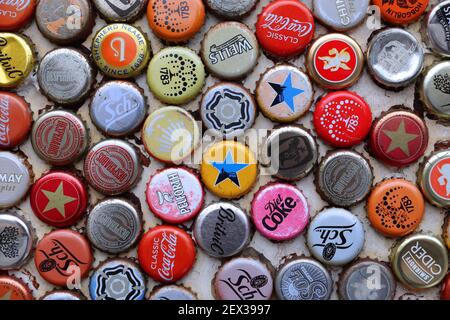LONDON, UK - JULY 13, 2019: Mixed beer and non alcoholic beverages metal bottle caps in London UK. Stock Photo