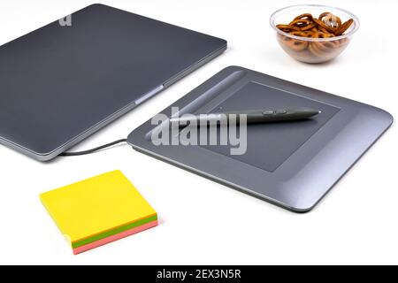 Closeup of a graphic tablet and pen on the designer's desk. Selective focus. Stock Photo
