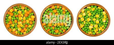 Mixed vegetables in wooden bowls. Three mixes of green peas, corn and carrot cubes. Mix of peas, carrots cut in cubes and vegetable maize. Stock Photo