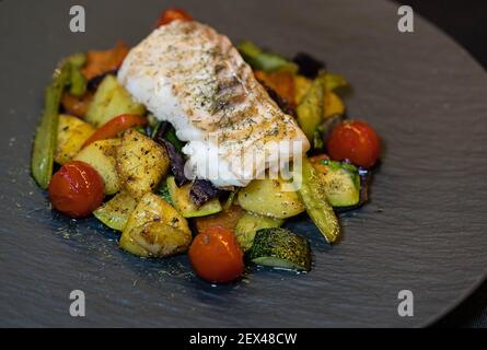 roasted cod fillet on mediterranean vegetables Stock Photo