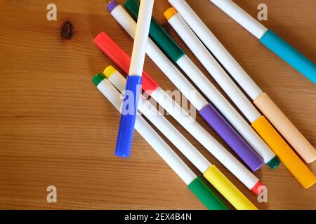 A set of multicolored felt pens on a wooden table Stock Photo