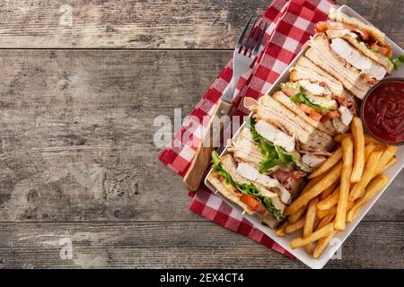 Club sandwich and French fries with ketchup sauce on wooden table Stock Photo