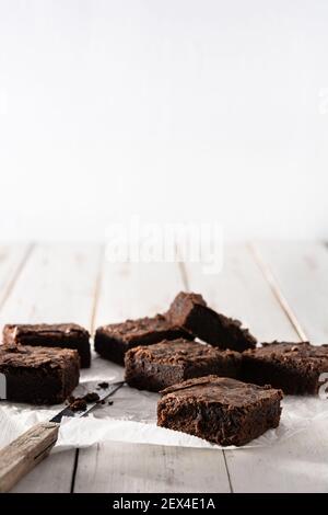 Homemade pieces of brownies on wooden table Stock Photo