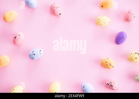 Multicolored motley Easter eggs on a pink background with a copy space for the text.  Stock Photo