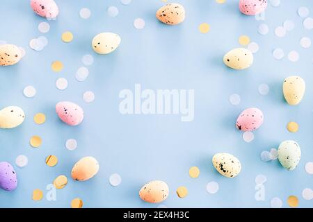 Multicolored motley easter eggs on a blue background with copy space for text Stock Photo