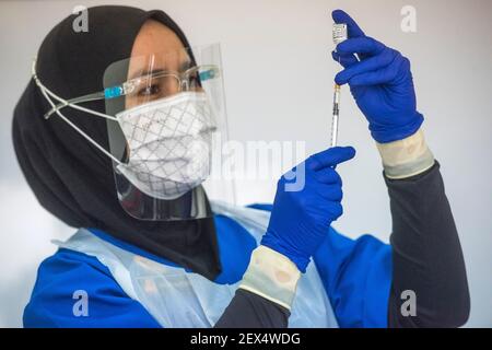 A health worker loads a syringe with a dose of the Pfizer-BioTech Covid-19 vaccine at the UiTM Hospital in Sungai Buloh. The Malaysia government says 500,000 front liners of the country nationwide are set to receive the first dose of the Covid-19 vaccine in the first quarter of this year. Stock Photo