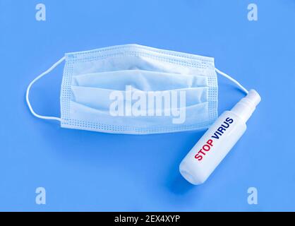 Surgical masks and hand sanitizer gel for hand hygiene spread protection. Stock Photo