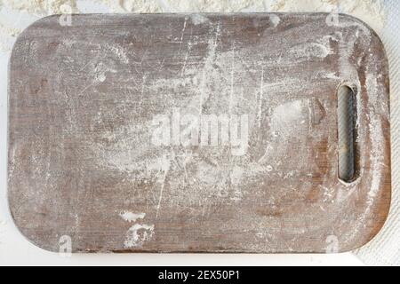 homemade dumplings in the kitchen without decorations. floured kitchen board with space for text Stock Photo