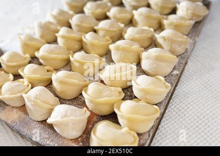 homemade dumplings in the kitchen without decorations. making dumplings with minced pork, beef and chicken Stock Photo