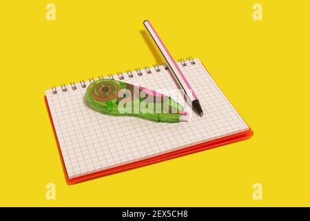 tape corrector and pen on a copybook Stock Photo