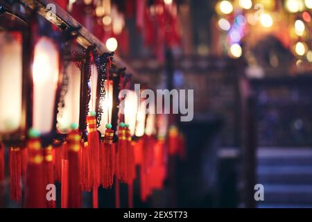 Selective focus on traditional red Chinese lanterns with blessings. Man Mo Temple, Hong Kong Stock Photo