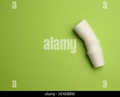 stack of white paper cups on a pink background. Plastic rejection concept, zero waste, copy space Stock Photo