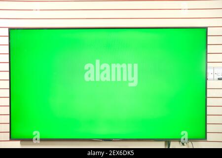 TV with Green Screen Mock Up Against Wall  Stock Photo