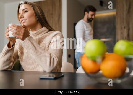 Caring wife serving serving breakfast for her husband Stock Photo
